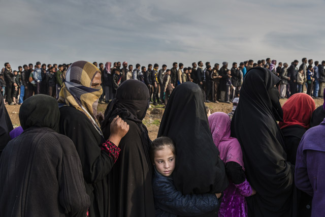 Ivor Prickett, Civilians who had remained in west Mosul during the battle to retake the city, lined up for an aid distribution in the Mamun neighbourhood. Iraq, March 2017. From the series: End of the Caliphate, 2016 – 2018 © Ivor Prickett, The New York Times