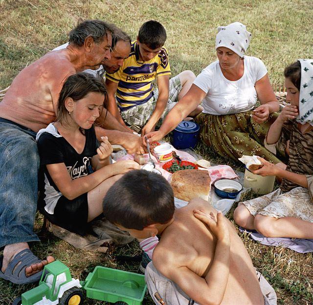 Rena Effendi, The Borca family relaxes after a working day that started early. Gheorghe and Anuța Borca were married in July 1995, in the middle of the grass-cutting season. The honeymoon had to be shortened. “We started making hay again one week after the wedding,” Anuța says ruefully. This photograph was made in Maramureș, the Romanian-speaking part of northern Transylvania, 2012. From the series: Transylvania: Built on Grass, 2012 © Rena Effendi, Prix Pictet